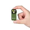 Mini lampe clip Olight Oclip Pro verte tenue entre les doigts montrant sa taille compacte EDC pour camping et quotidien
