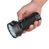 Olight MARAUDER MINI noire avec des détails bleus, tenue en main pour l'éclairage extérieur.